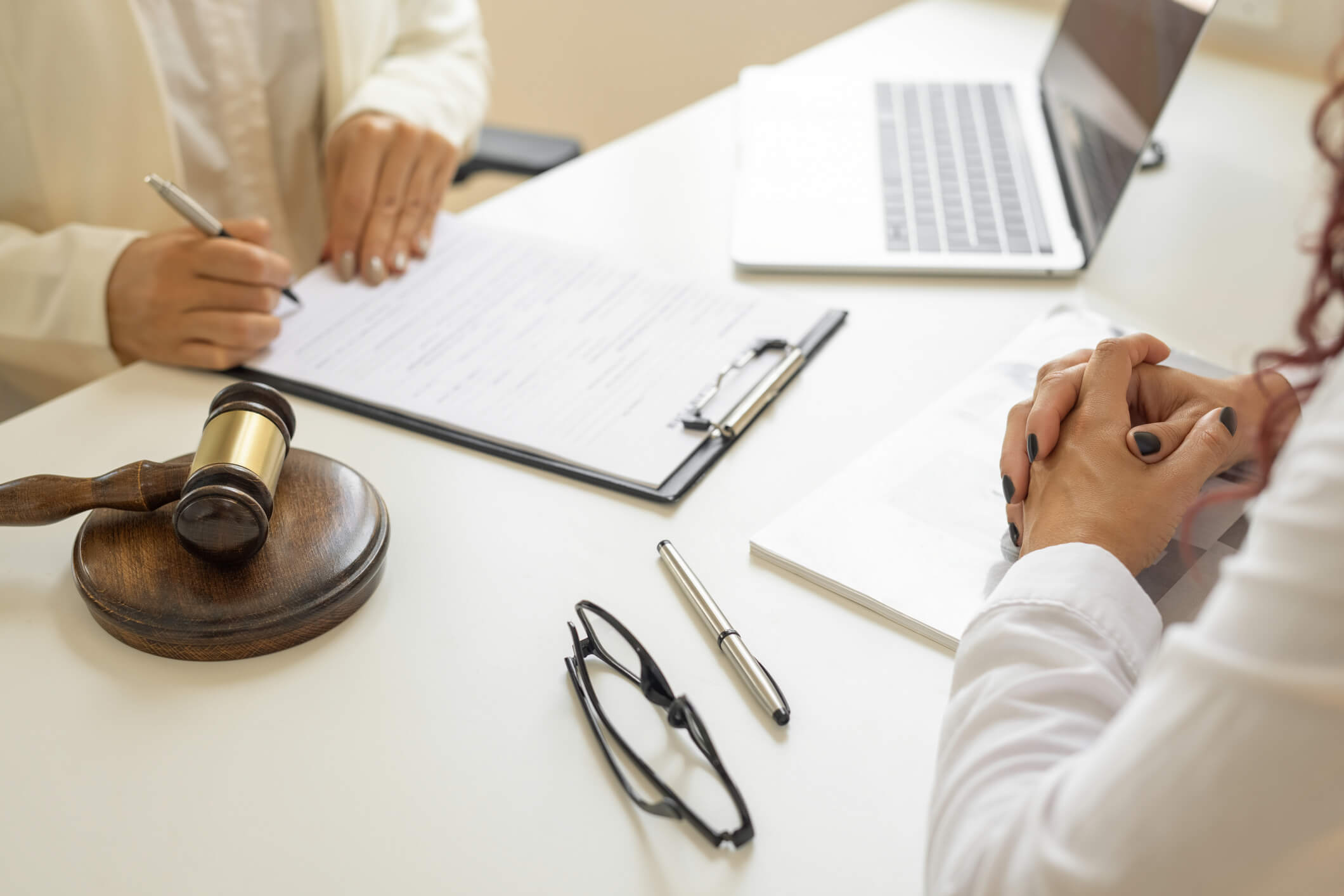 Legal meeting with notepad and gavel
