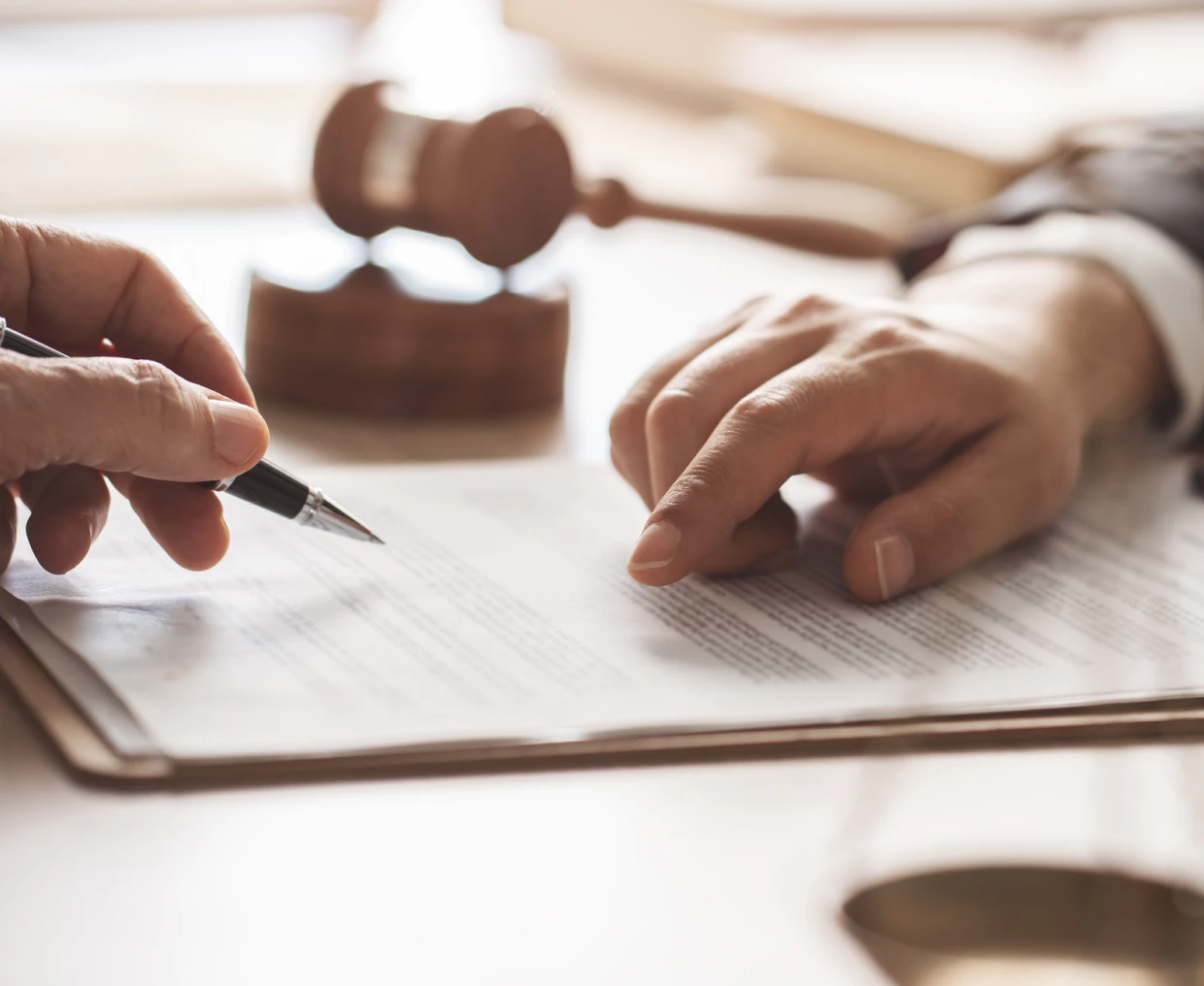 Close-up of hands signing paperwork